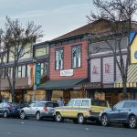 Downtown Sebastopol street with local art galleries, boutiques, and pedestrians along a tree‑lined shopping district in Sonoma County, CA.